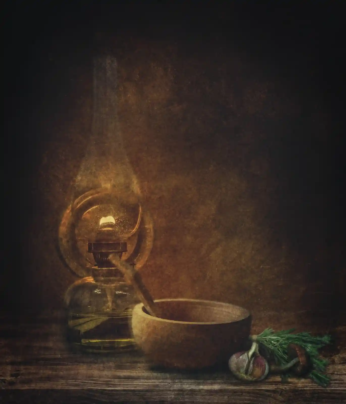 A softly glowing oil lamp sits on a wooden surface beside a bowl and a sprig of herbs. The darkness crowds in around the warmth, and an unspoken comfort seeps out. It is a place of stillness, where time ceases to matter and old stories resurface in the flicker of a flame.